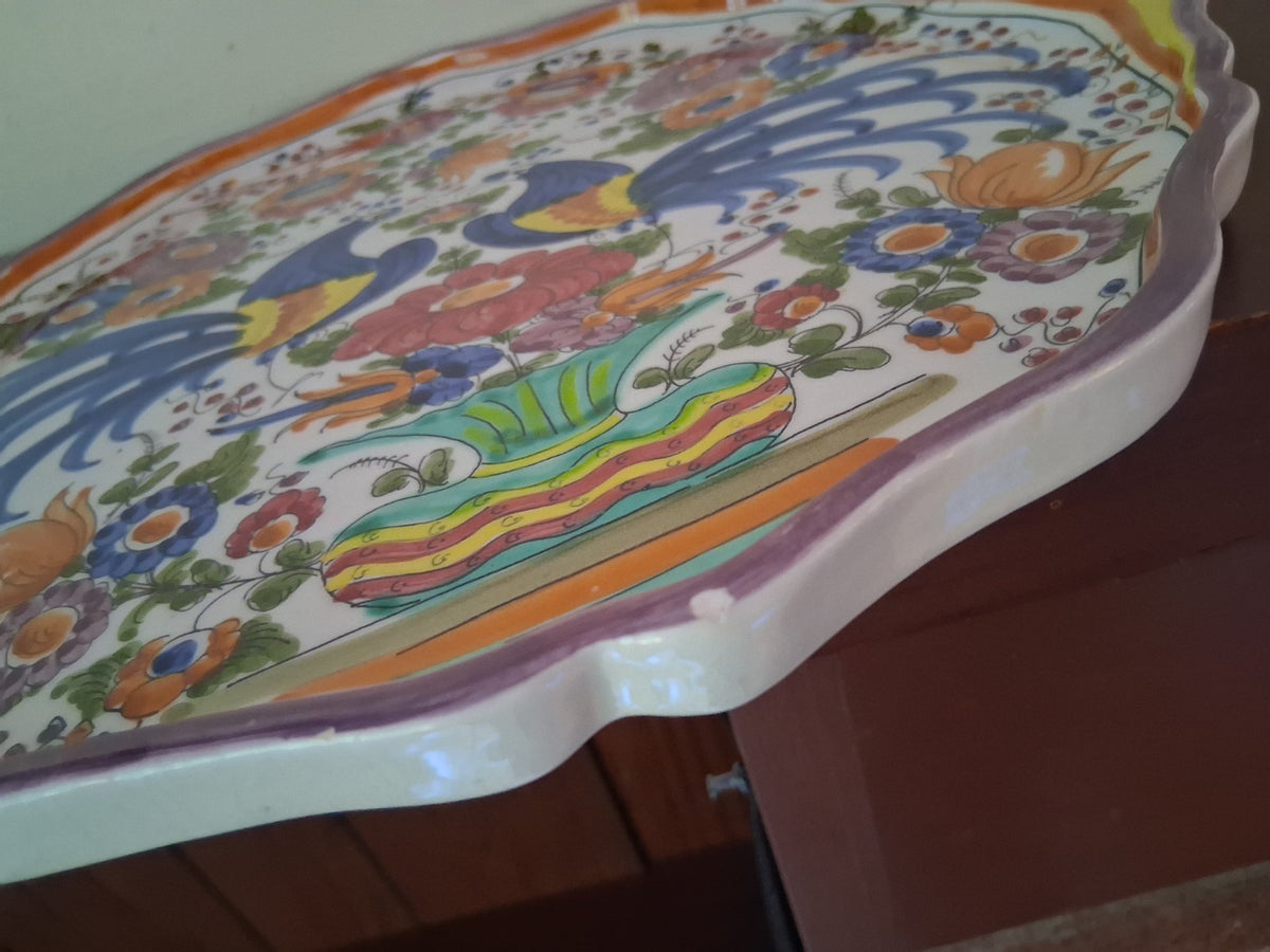 Hand-painted ceramic decorative plate with peacock and floral motif
