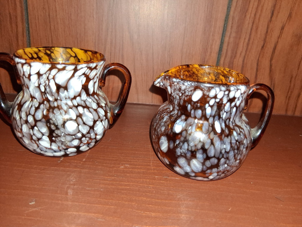 Pair of pressed glass sugar bowls in amber carnival glass Star and File pattern