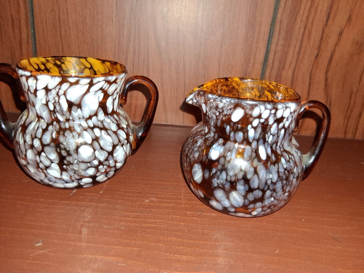 Pair of pressed glass sugar bowls in amber carnival glass Star and File pattern