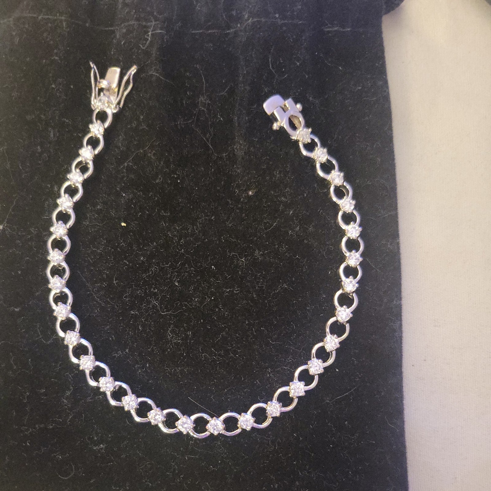 Tennis bracelet with oval-cut gems and diamond accents 8" 12.89g