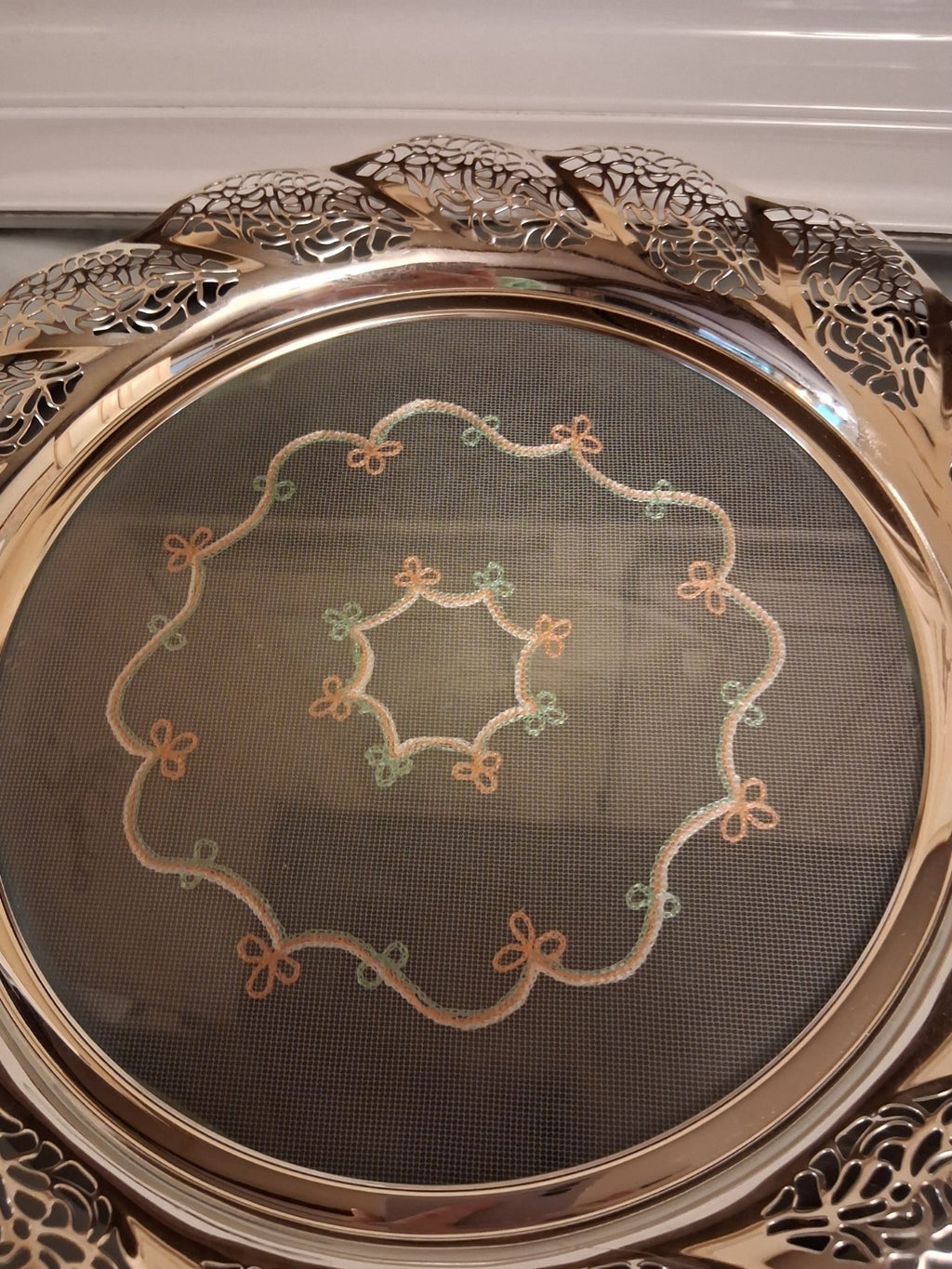 Silver-plated oval serving tray with ornate grapevine border and enamel center