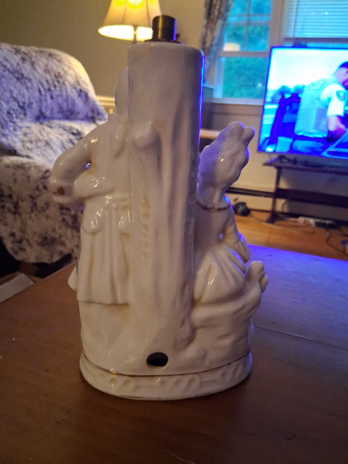 Porcelain figurine depicting a Victorian courting couple in white with gold...