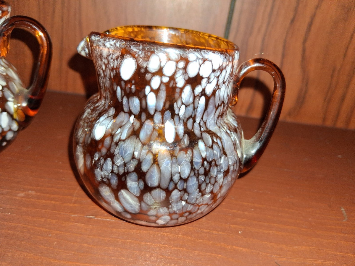 Pair of pressed glass sugar bowls in amber carnival glass Star and File pattern