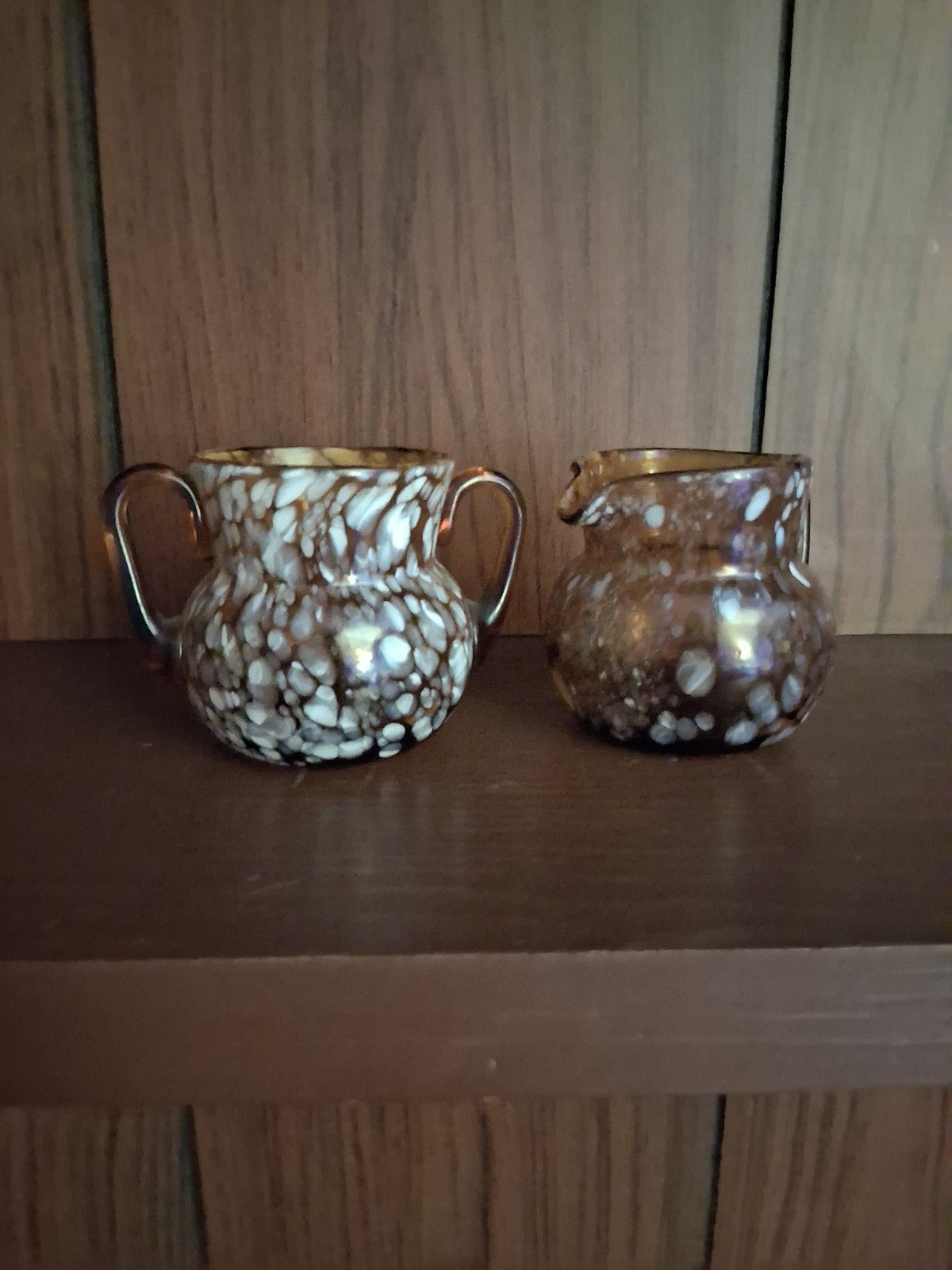 Pair of pressed glass sugar bowls in amber carnival glass Star and File pattern