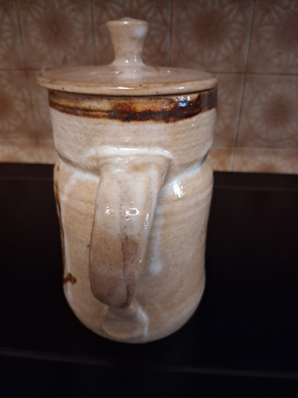 Stoneware studio pottery pitcher with abstract botanical decoration