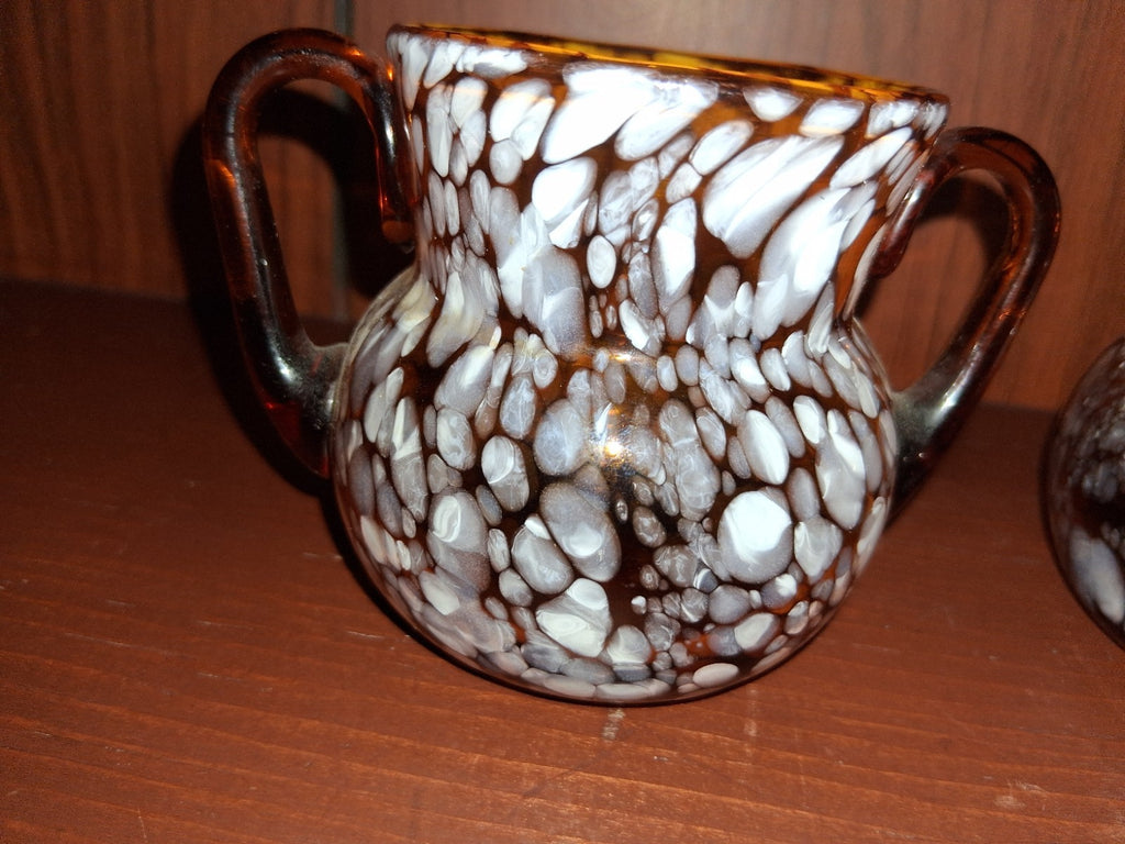 Pair of pressed glass sugar bowls in amber carnival glass Star and File pattern