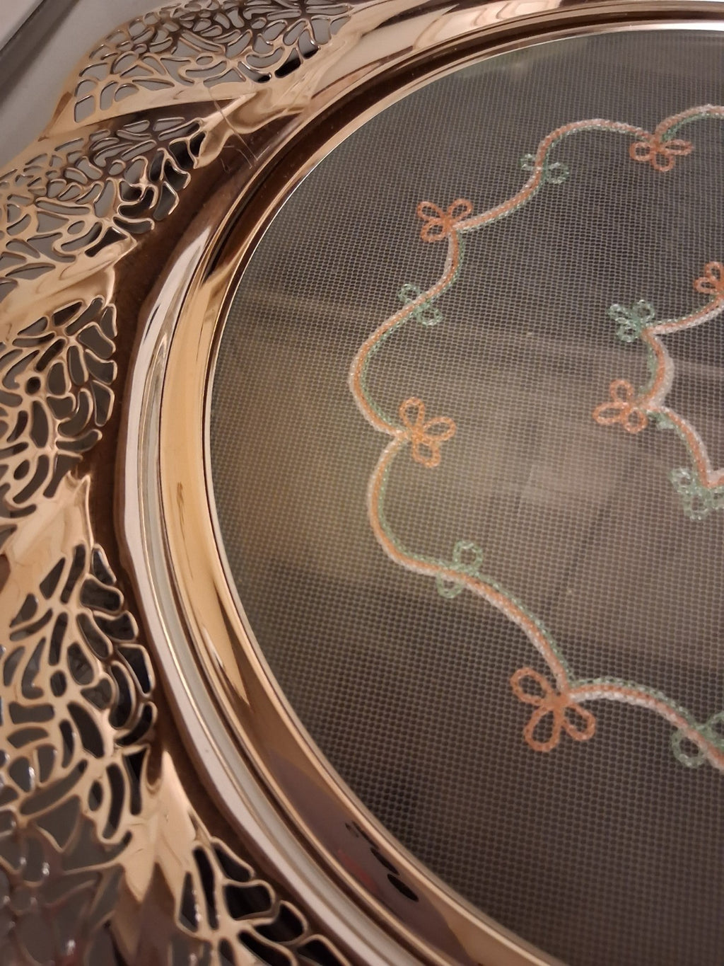 Silver-plated oval serving tray with ornate grapevine border and enamel center