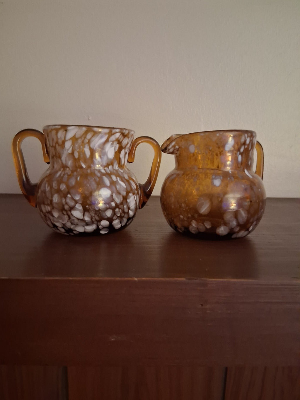 Pair of pressed glass sugar bowls in amber carnival glass Star and File pattern