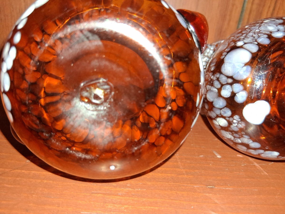 Pair of pressed glass sugar bowls in amber carnival glass Star and File pattern