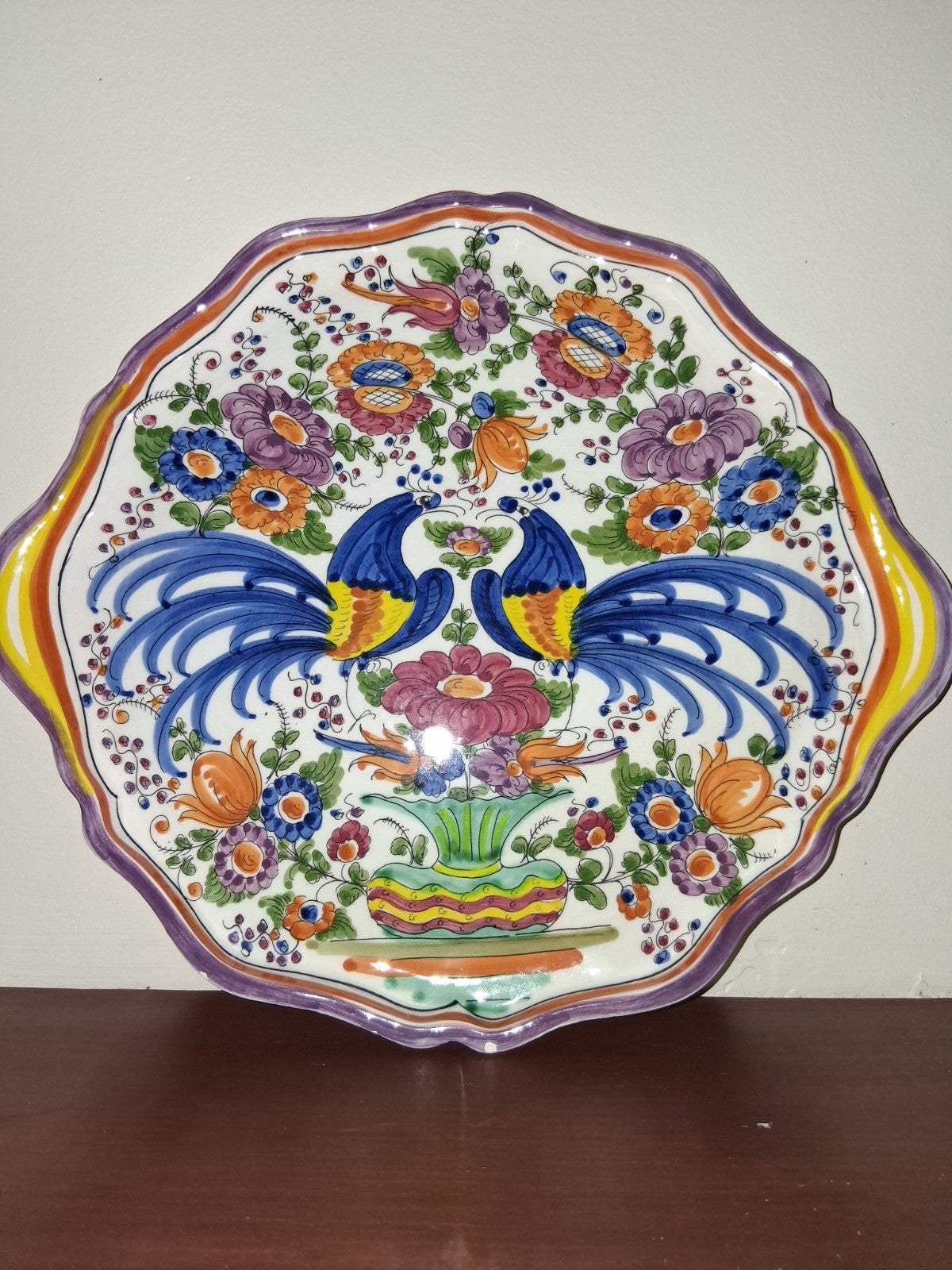 Hand-painted ceramic decorative plate with peacock and floral motif