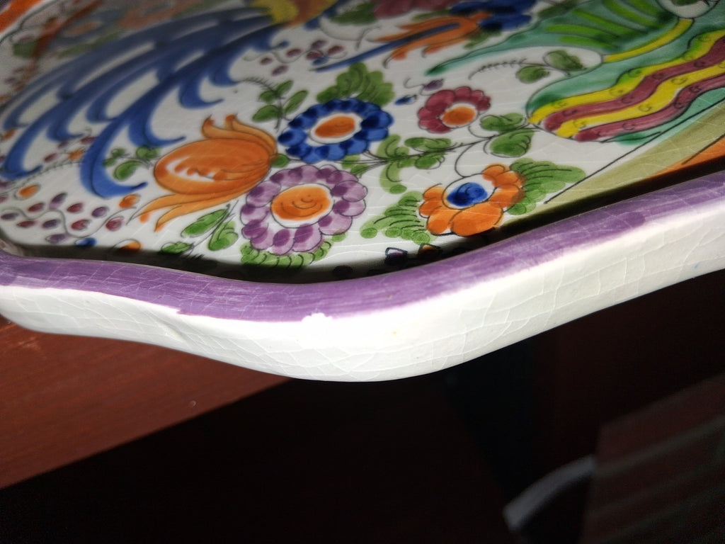 Hand-painted ceramic decorative plate with peacock and floral motif