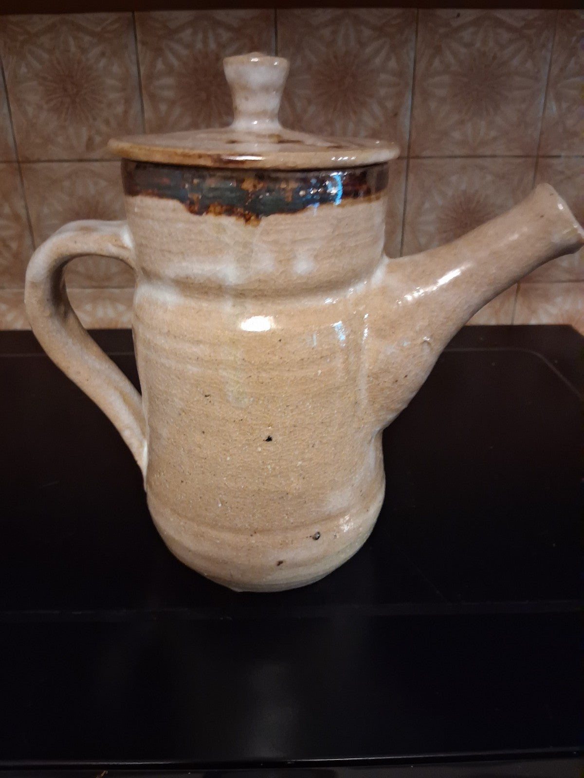 Stoneware studio pottery pitcher with abstract botanical decoration