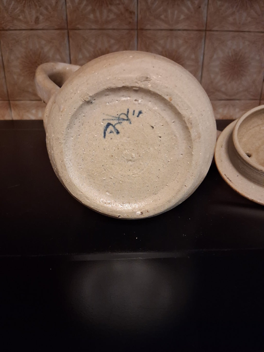 Stoneware studio pottery pitcher with abstract botanical decoration