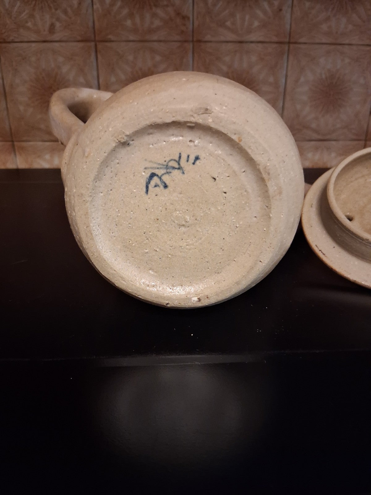 Stoneware studio pottery pitcher with abstract botanical decoration