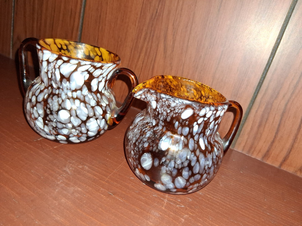 Pair of pressed glass sugar bowls in amber carnival glass Star and File pattern