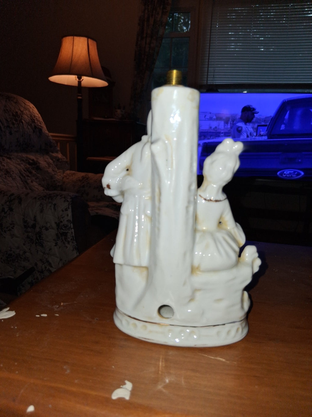 Porcelain figurine depicting a Victorian courting couple in white with gold...
