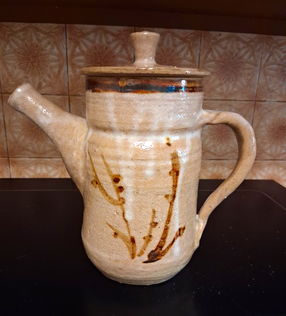 Stoneware studio pottery pitcher with abstract botanical decoration