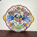 Hand-painted ceramic decorative plate with peacock and floral motif